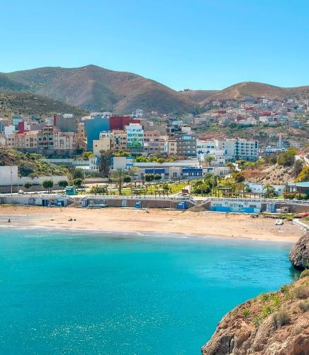a view of a beach with a city in the background at Family Stay with Lovely View ALhoceima in Al Hoceïma