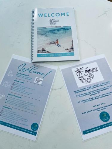 a table with three brochures on it at Renovated Family Beach House, Walk to Sand in Cabarita Beach