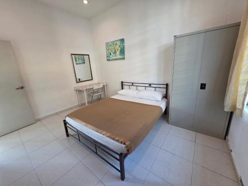 a small bedroom with a bed and a mirror at Siantan In Paya Rumput Near Std Hang Jebat, Sg Udang & UITM Lendu in Melaka