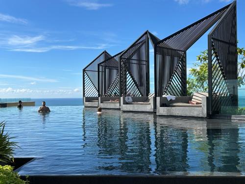 a swimming pool with people in the water at Edge Central Pattaya By YoYo in Pattaya Central