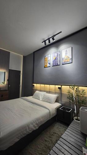 a bedroom with a large bed and pictures on the wall at bonheur house betong in Betong