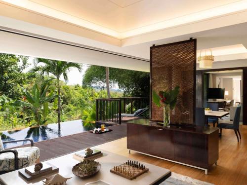 a living room with a large mirror in the middle at Raffles Seychelles in Baie Sainte Anne