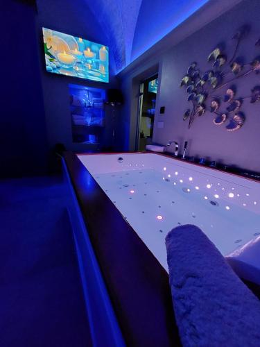 a large bathroom with a tub with blue lighting at Siramà Suite Deluxe in Oria