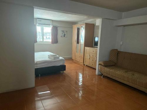 a living room with a bed and a couch at Big Moose Pattaya in Ban Nong Chaeng