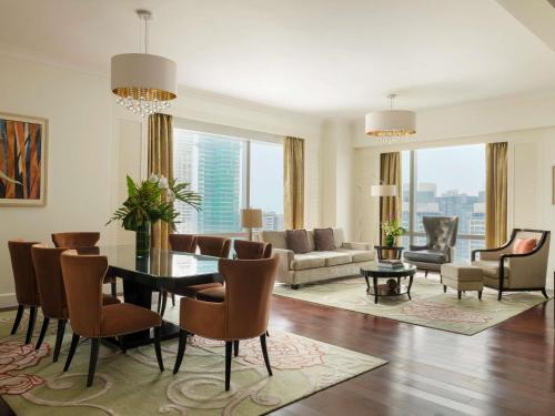 a living room with a table and chairs and a couch at Raffles Makati in Manila