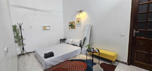 a room with a bed and a table in it at Bu studio 46 Nam Ngư in Hanoi