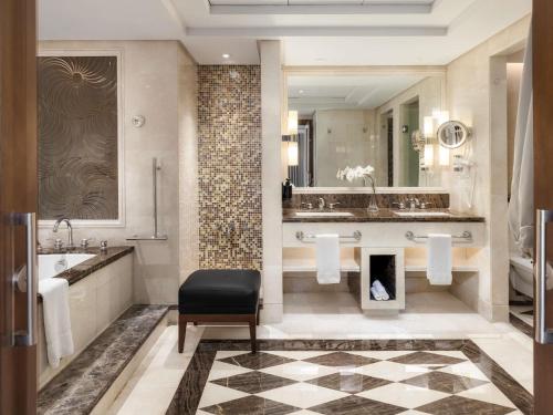 a bathroom with a sink and a fireplace at Raffles Makkah Palace in Makkah