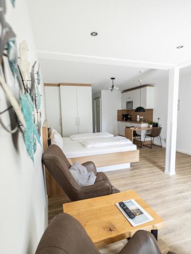 a living room with a couch and a table at Haus NordQuartier in Norderney