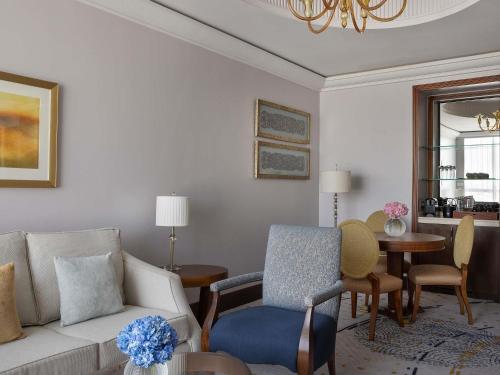 a living room with a couch and a table at Raffles Makkah Palace in Makkah