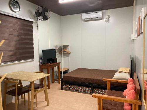 a small room with a bed and a table at Ays homestay in Puerto Princesa City