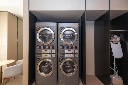 two washing machines are stacked in a room at JI Hotel Shanghai Caohejing Caobao Road in Shanghai