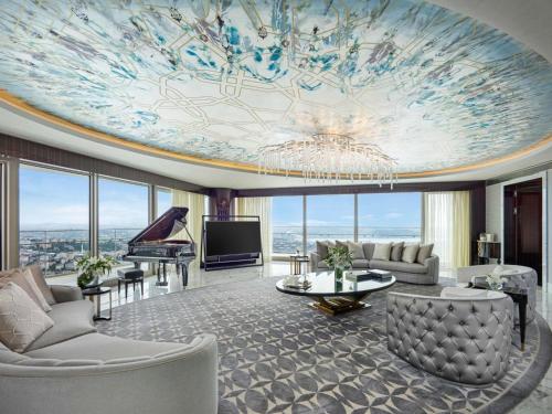 a living room with a ceiling with a painting on it at Raffles Istanbul in Istanbul