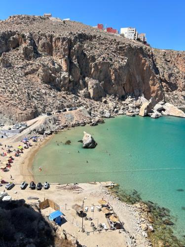 an aerial view of a beach with people in the water at Family Stay with Lovely View ALhoceima in Al Hoceïma