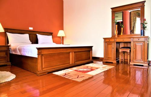 a bedroom with a bed and a large mirror at Diplomat Furnished Apartments in Addis Ababa