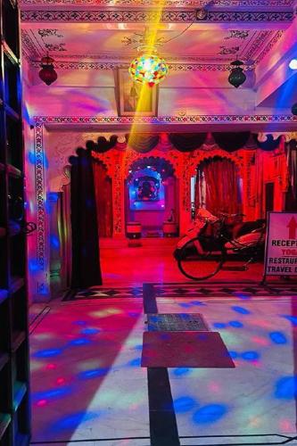a room with red and blue lights on a dance floor at Nukkad Guest House Near Lake Pichola in Udaipur