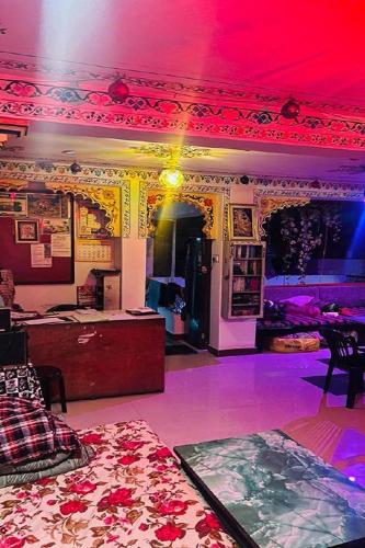 a room with a red ceiling and a room with a bed at Nukkad Guest House Near Lake Pichola in Udaipur