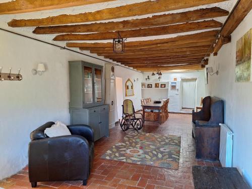 a living room with two chairs and a table at Can Pedragos in Sales del Llierca