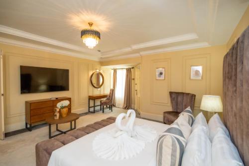a hotel room with a bed and a television at Bukit Merah Laketown Resort in Taiping