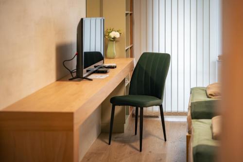 a room with a desk with a computer and a chair at TRINAVIS Boutique Apartments, OWN PRIVATE PARKING, City Center, Entire Apartment in Veliko Tŭrnovo