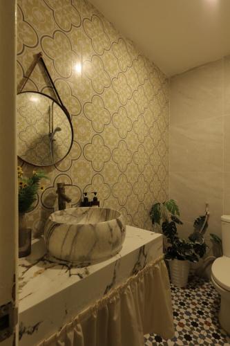 a bathroom with a sink and a toilet at Langmandi Experience Ấu Triệu in Hanoi
