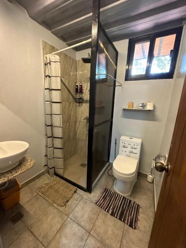 a bathroom with a shower and a toilet and a sink at Ina Homestay in Coron