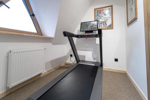 a treadmill in a room with a window at Panocek i Babka in Białka Tatrzanska