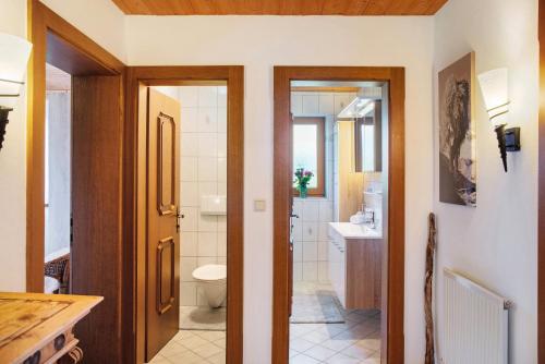 a bathroom with a toilet and a sink at Apart Mia in Grossried
