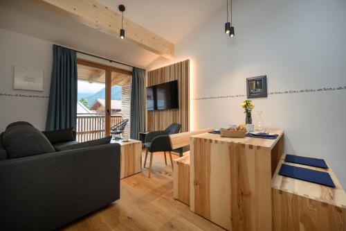 a living room with a couch and a table at Haus Sternenhimmel in Oberammergau