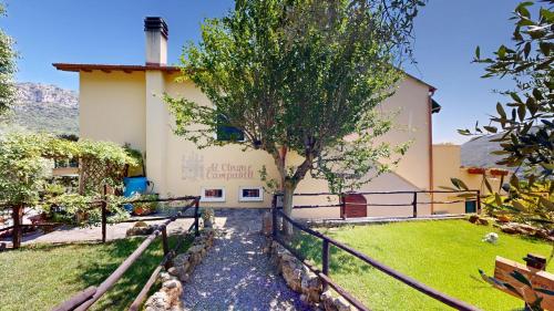 a building with a tree in front of it at Ai Cinque Campanili in Finale Ligure