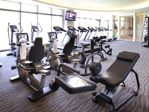 a gym with several treadmills and cardio machines at Fairmont Yangcheng Lake in Kunshan