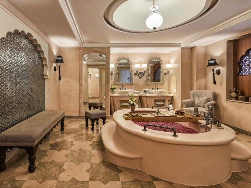 a large bathroom with a tub and a sink at Fairmont Jaipur in Jaipur