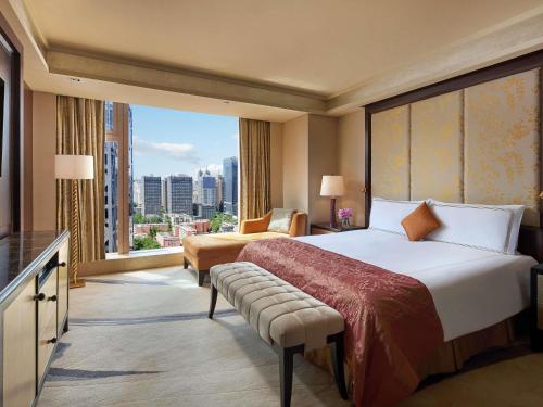 a hotel room with a bed and a large window at Fairmont Beijing - 20 minutes to Forbidden City by metro in Beijing
