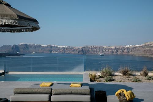 a living room with a view of a body of water at Melidonia Suites in Akrotiri