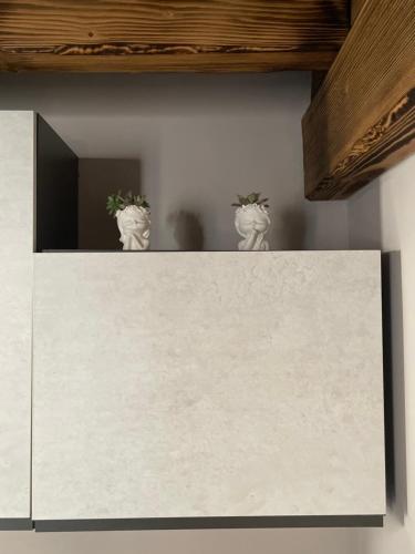 three potted plants sitting on top of a white cabinet at Dimora Rosaspina in Adro