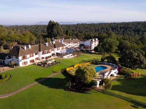 an aerial view of a resort with a swimming pool at Fairmont Mount Kenya Safari Club in Nanyuki