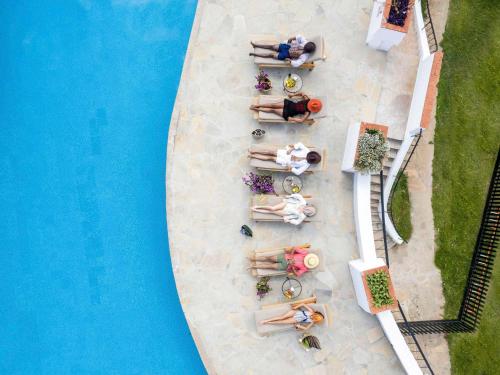 an overhead view of a swimming pool with people laying around it at Fairmont Mount Kenya Safari Club in Nanyuki