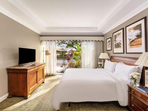 a bedroom with a large bed and a television at Fairmont The Norfolk in Nairobi