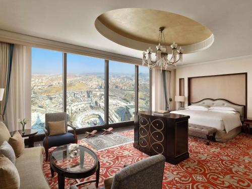 a hotel room with a bed and a large window at Makkah Clock Royal Tower, A Fairmont Hotel in Makkah