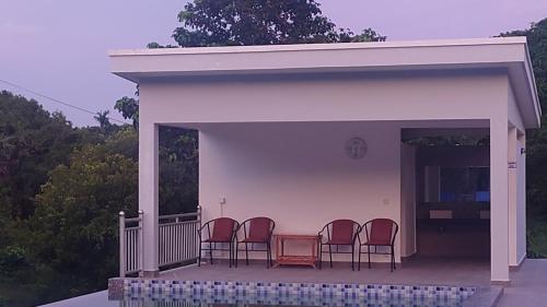 a group of chairs sitting on a porch at Sivann Villa Kep in Kep