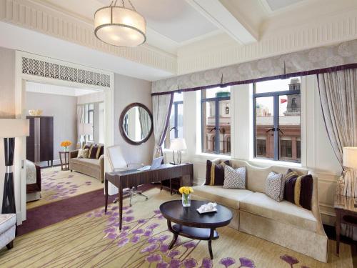 a living room with a couch and a table at Fairmont Peace Hotel on the Bund in Shanghai