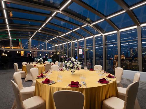 a conference room with tables and chairs and windows at Fairmont Peace Hotel on the Bund in Shanghai