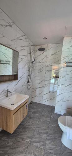 a bathroom with a sink and a toilet at Palika Sun House in Amphoe Koh Samui