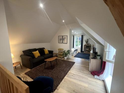 a living room with a couch and a table at Coup de coeur en Alsace in Haguenau