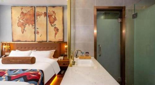 a bedroom with a bed and a bathroom with a sink at James Joyce Coffetel·Lijiang Old Town Centeral in Lijiang