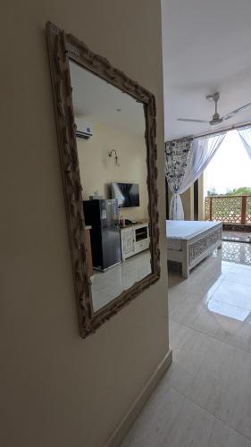 a mirror hanging on a wall in a living room at Mulla Apartments in Malindi