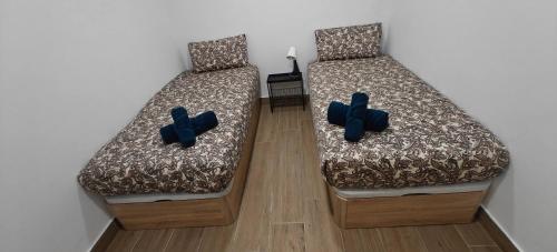 two beds with crosses on them in a room at Exquisite Flat in Martorell (Barcelona) in Martorell