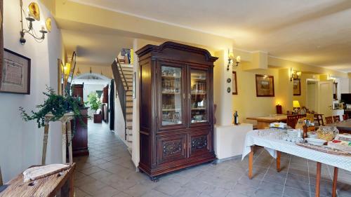 a room with a wooden cabinet with dishes in it at Ai Cinque Campanili in Finale Ligure