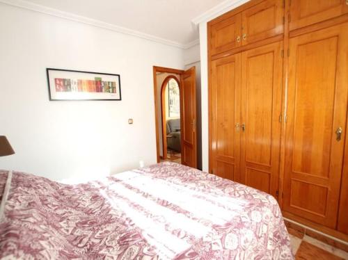 a bedroom with a bed and wooden cabinets at Enjoy a stylish experience at this centrally-located place ! in Dublin