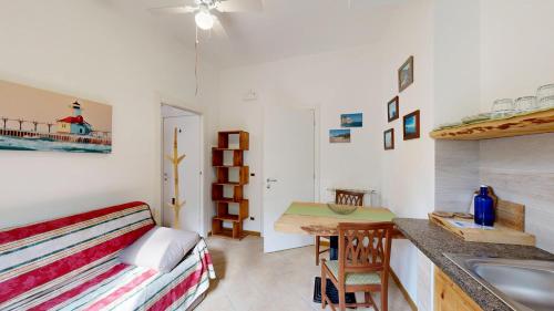 a kitchen with a sink and a table in a room at Ai Cinque Campanili in Finale Ligure