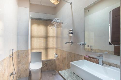 a bathroom with a toilet and a sink and a tub at Royal Boutique Hotel in Kathmandu